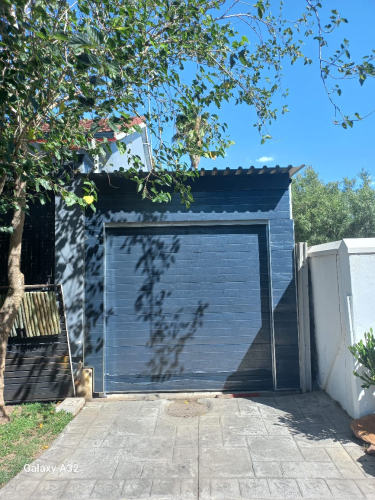 Garage door with cladded garage door panels